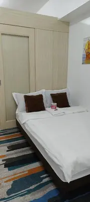 a bedroom with a large white bed with two pillows at Jazz Apartment Unit in Manila