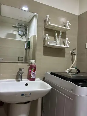 a bathroom with a sink and a mirror at Shore 2 Residences Mall of Asia staycation in Manila