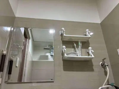 a bathroom with a mirror and a sink and a shower at Shore 2 Residences Mall of Asia staycation in Manila