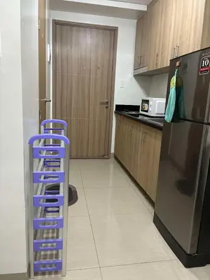 a kitchen with a blue ladder next to a refrigerator at Shore 2 Residences Mall of Asia staycation in Manila