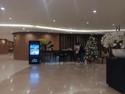 a lobby with a christmas tree in the middle at Shore 2 Residences Mall of Asia staycation in Manila