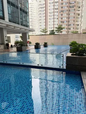 a large swimming pool in a building with tall buildings at Rustic Elegance New One Bedroom One Uptown Free parking in Manila