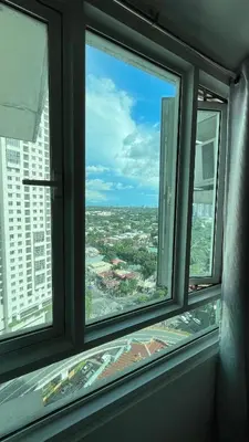a view of a city from an office window at Cozy Condo Beacon Tower Makati in Manila