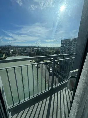 a balcony of a building with a view of a city at Bloom Residences by Casa Stellar in Manila