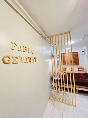 a bedroom with a bed with a sign on the wall at Fablo Getaway beside EK in Santa Rosa
