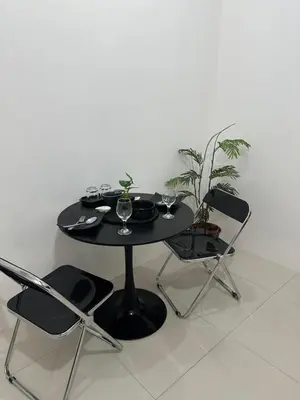 a black table and chairs with glasses on it at Relaxing Suite Across NAIA Terminal 3 in Manila