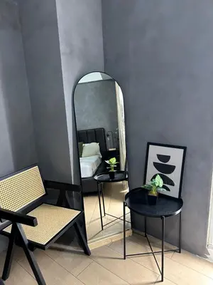 a room with a mirror and two chairs and a table at Relaxing Suite Across NAIA Terminal 3 in Manila