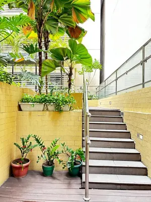 a set of stairs with potted plants in a building at Relaxing Suite Across NAIA Terminal 3 in Manila