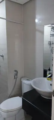 a bathroom with a toilet and a sink at 150 Newport Blvd Condotel near T3 by Alps in Manila