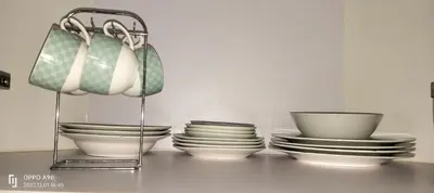 a group of bowls and plates sitting on a table at ROOM NEAR AIRPORT BY RQUi in Manila