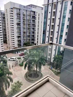 a view from the balcony of a building with a palm tree at ROOM NEAR AIRPORT BY RQUi in Manila