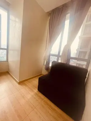 a living room with a couch in front of a window at 2BR-T31807 Sunshine100 Pool Billiard 70 inches TV Karaoke in Manila