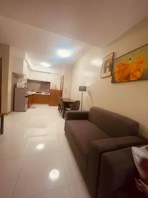 a living room with a couch and a kitchen at 2BR-T31807 Sunshine100 Pool Billiard 70 inches TV Karaoke in Manila