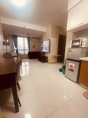 a living room with a kitchen with a stove and refrigerator at 2BR-T31807 Sunshine100 Pool Billiard 70 inches TV Karaoke in Manila
