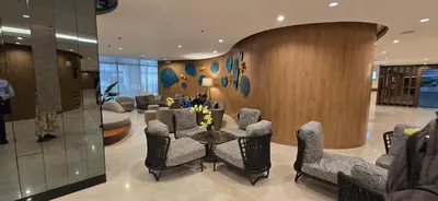 a lobby with a waiting room with chairs and a table at Jay Suite in Manila