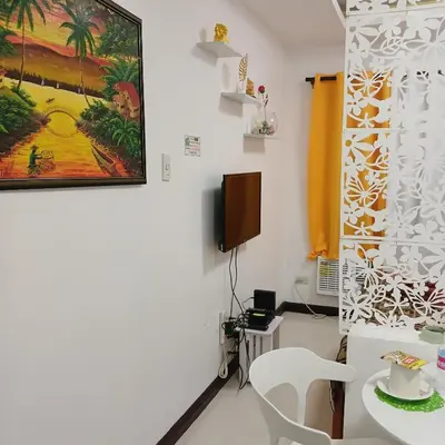 a room with a table and a painting on the wall at Birch Tower by the Bay Studio type in Manila