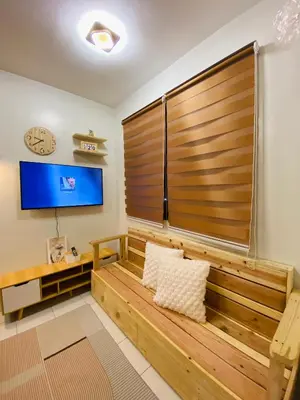 a living room with a large wooden partition with a tv at Fablo Getaway in Santa Rosa