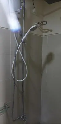 a shower with a white shower head in a bathroom at Charlie's Penthouse in Mall of Asia Complex in Manila