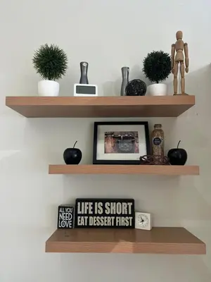 a shelf with some plants and a picture on it at Makati High rise 1 Bedroom Condo with Balcony in Manila
