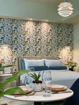 a bedroom with a bed and a table with glasses at Chic and modern studio in Manila
