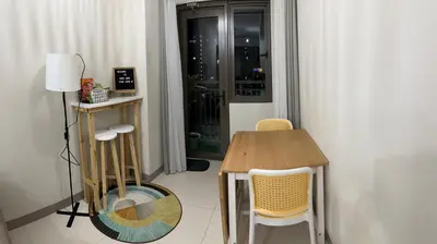 a table and chairs in a room with a window at Home Away From Home - S Residences in Manila