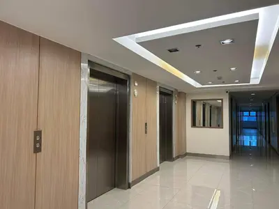 a hallway of a office building with a ceiling at Home Away From Home - S Residences in Manila