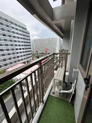 a balcony with a view of a building at Home Away From Home - S Residences in Manila