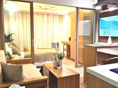 a living room with a bed and a large mirror at Azure urban resort residences, BAHAMAS tower Japandi model in Manila