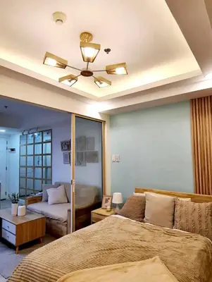 a bedroom with a bed and a ceiling fan at Azure urban resort residences, BAHAMAS tower Japandi model in Manila
