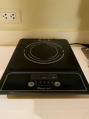 a black stove top oven sitting on top of a counter at Azure Staycation by the clouds in Manila