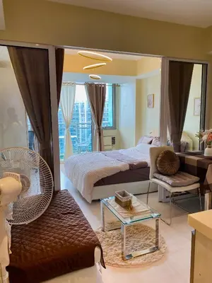 a bedroom with a large bed and a mirror at Azure Staycation by the clouds in Manila