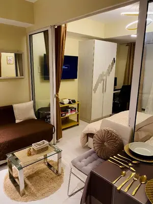 a living room with a couch and a table at Azure Staycation by the clouds in Manila
