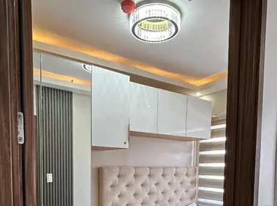 a kitchen with a ceiling with a light and a couch at Golden Scape 1 Bedroom near NAIA Airport in Manila