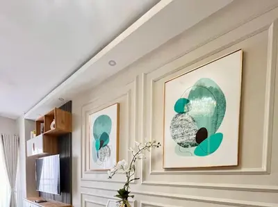 a living room with two pictures on the wall at Golden Scape 1 Bedroom near NAIA Airport in Manila