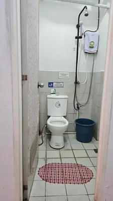 a small bathroom with a toilet and a shower at Marco's Economy Room For Rent near NAIA in Manila