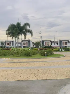a parking lot with houses and palm trees at Homestay at Phirst Park Homes Tanza in Tanza