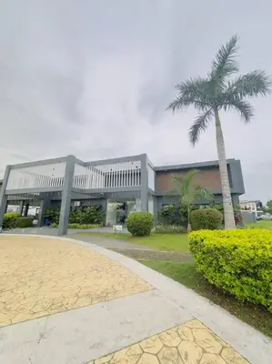 a building with a palm tree in front of it at Homestay at Phirst Park Homes Tanza in Tanza