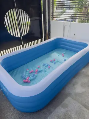 a blue tub of water with flowers in it at Homestay at Phirst Park Homes Tanza in Tanza