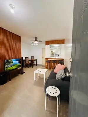 a living room with a couch and a tv at Homestay at Phirst Park Homes Tanza in Tanza
