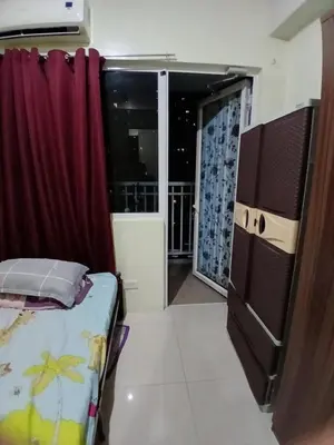 a small room with a bed and a kitchen at Breeze Residences in Manila
