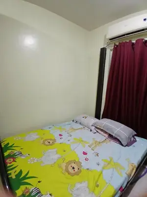 a bed with a blanket with animals on it at Breeze Residences in Manila