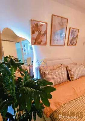 a bedroom with a bed and a plant in it at Azure Staycation by Oveecation Suites in Manila