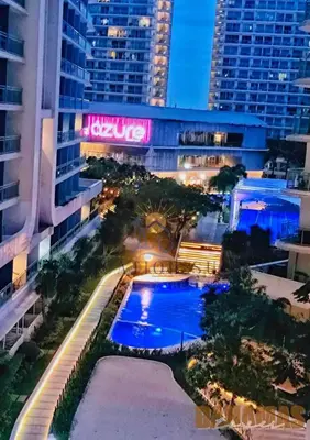 an overhead view of a pool in a city at night at Azure Staycation by Oveecation Suites in Manila