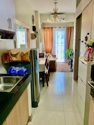 a kitchen and a living room with a couch at MG Place -2 BR condo unit at SMDC Charm Residences, Cainta, Rizal, 1900 in Cainta