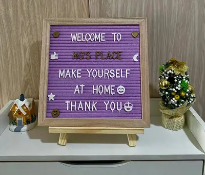 a sign on top of a shelf with a christmas tree at MG Place -2 BR condo unit at SMDC Charm Residences, Cainta, Rizal, 1900 in Cainta