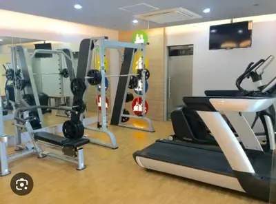 a gym with treadmills and ellipticals in a room at one palm tree villas &two palm tree villas in Manila