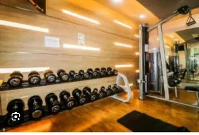 a gym with a bunch of dumbbells on a wall at one palm tree villas &two palm tree villas in Manila
