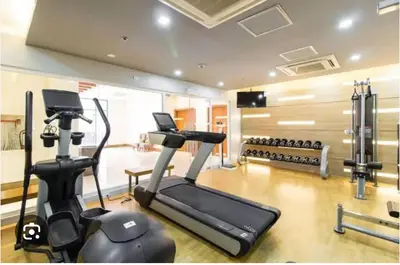 a gym with a treadmill and a elliptical machine at one palm tree villas &two palm tree villas in Manila