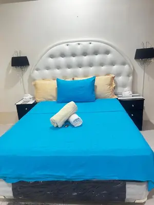 a blue bed with two towels on top of it at one palm tree villas &two palm tree villas in Manila
