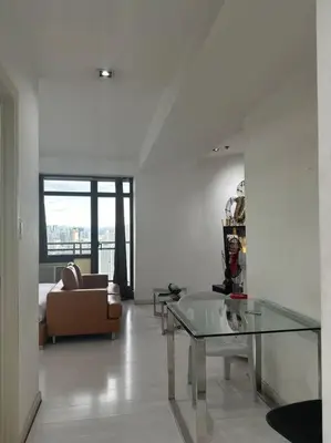 a living room with a couch and a glass table at Gramercy Studio on 52nd Floor Rockwell View Free WiFi in Manila